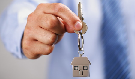 Man handing over house keyring